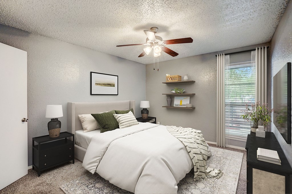 our apartments offer a bedroom with a large bed and a ceiling fan