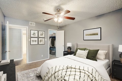 an open bedroom with a large bed and a ceiling fan