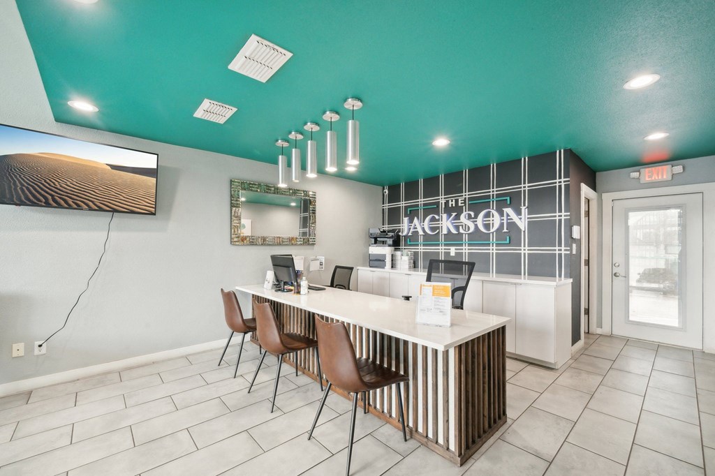 a lobby with a reception desk and chairs