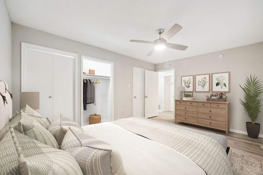 a bedroom with a large bed and a ceiling fan