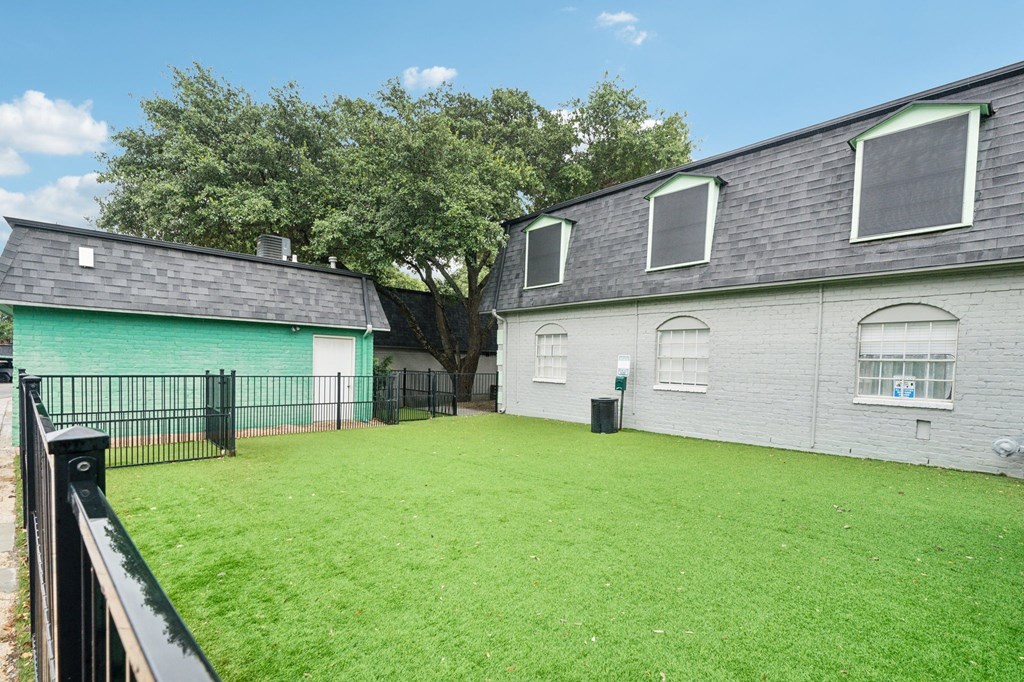 the backyard of a house with a yard and a fence