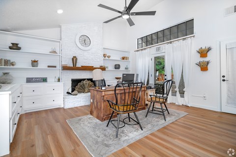 A living room with a fireplace and a dining table set up.