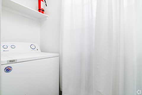 A white washing machine with a blue and white sticker on it.