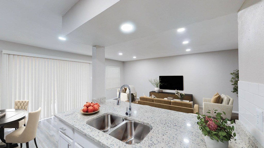 a kitchen with a sink and a tv in the background at The Frederick, San Antonio, 78240