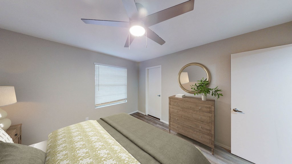 a bedroom with a ceiling fan and a dresser with a plant at The Frederick, Texas, 78240