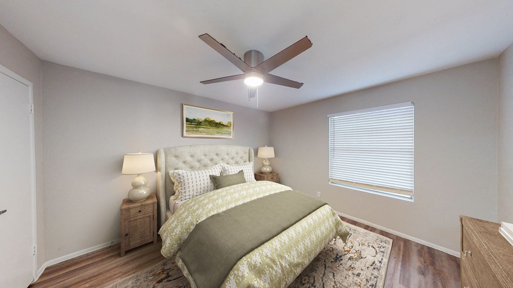 a bedroom with a bed and a ceiling fan at The Frederick, Texas