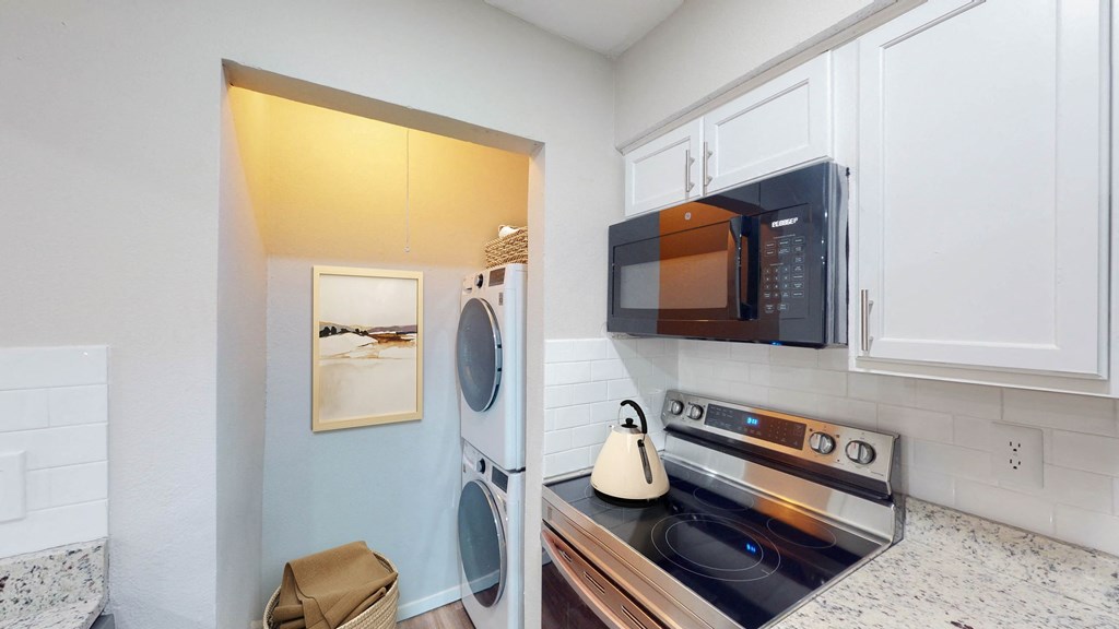 a laundry room with a washer and dryer at The Frederick, San Antonio, TX 78240