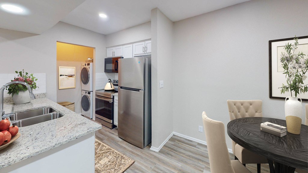 a kitchen and dining area in a 555 waverly unit at The Frederick, San Antonio