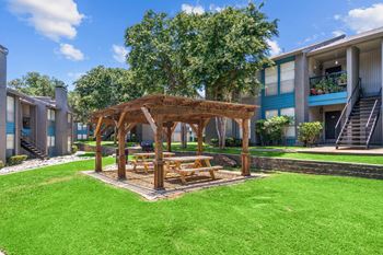 a wooden gazebo with a picnic table in the middle of a grassy area  at Vesper, Texas, 75254