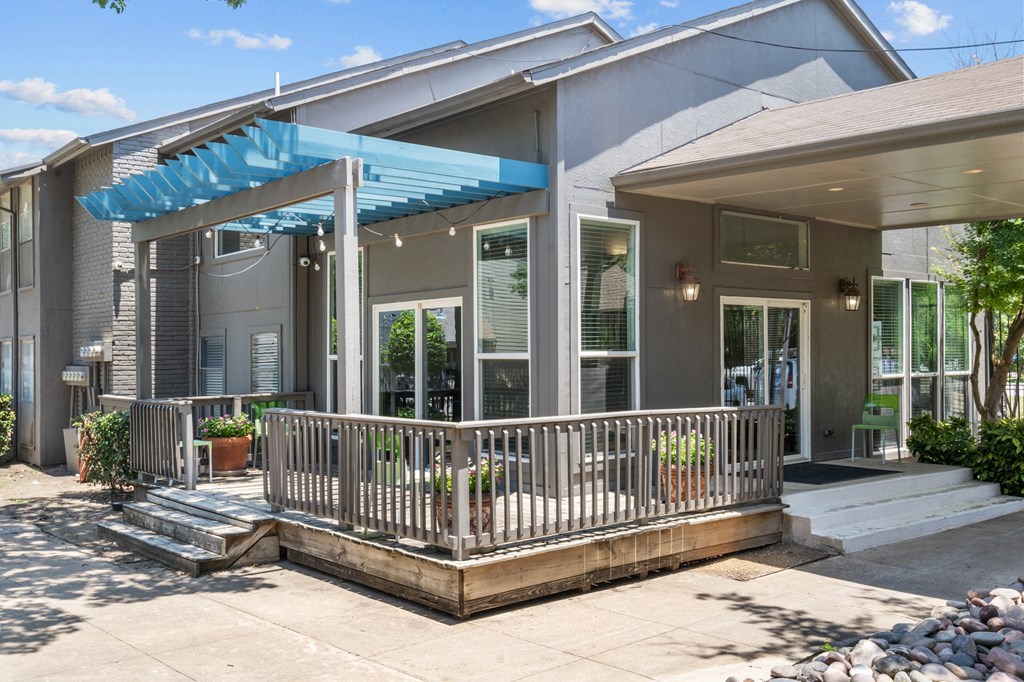 a patio with a blue awning in front of a gray house  at Vesper, Dallas, 75254