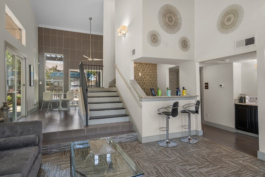 a kitchen and living room with a staircase leading up to the second floor  at Vesper, Dallas, TX