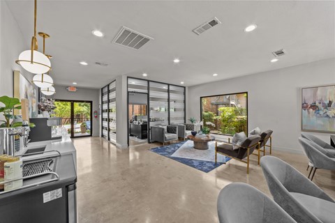 A modern living room with a kitchen area in the background.