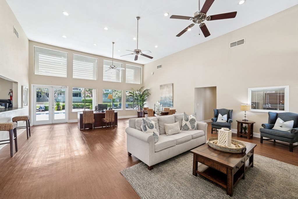 A living room with a white couch and a coffee table.