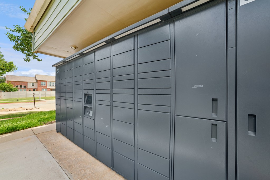 A grey storage unit with a door and a small window.