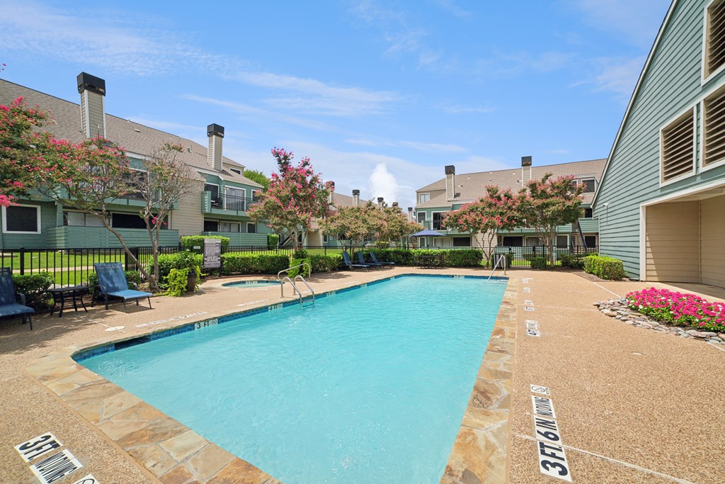 A swimming pool surrounded by a stone border with the number 37161 painted on it.