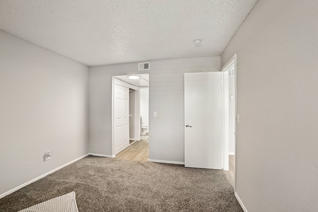 A room with a carpeted floor and white walls.
