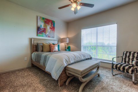 Spacious bedroom with modern furnishings at Waters Edge Villas Apartments, Rowlett, 75088