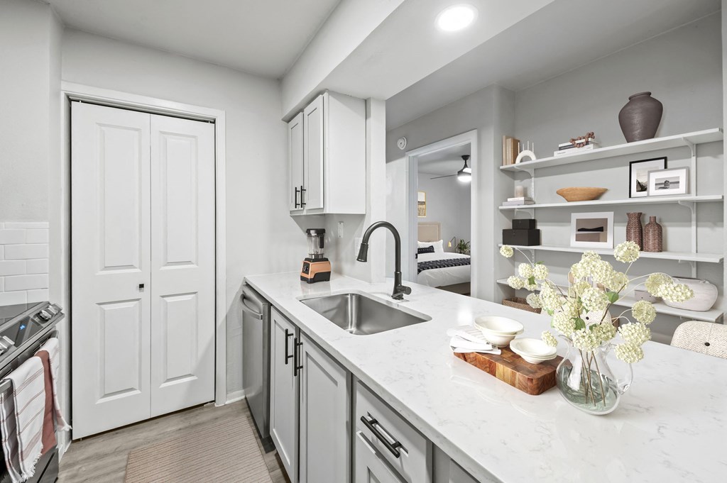a kitchen with white cabinets and a white counter top  at Carmel at Deerfield, San Antonio
