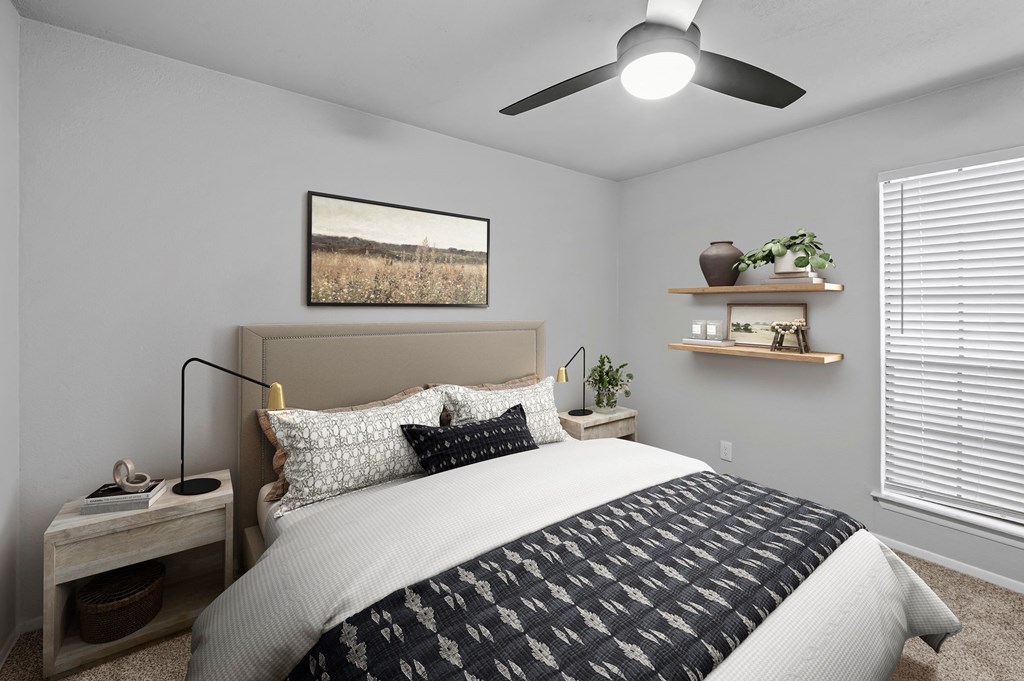 a bedroom with a ceiling fan and a window with a blind  at Carmel at Deerfield, San Antonio, Texas