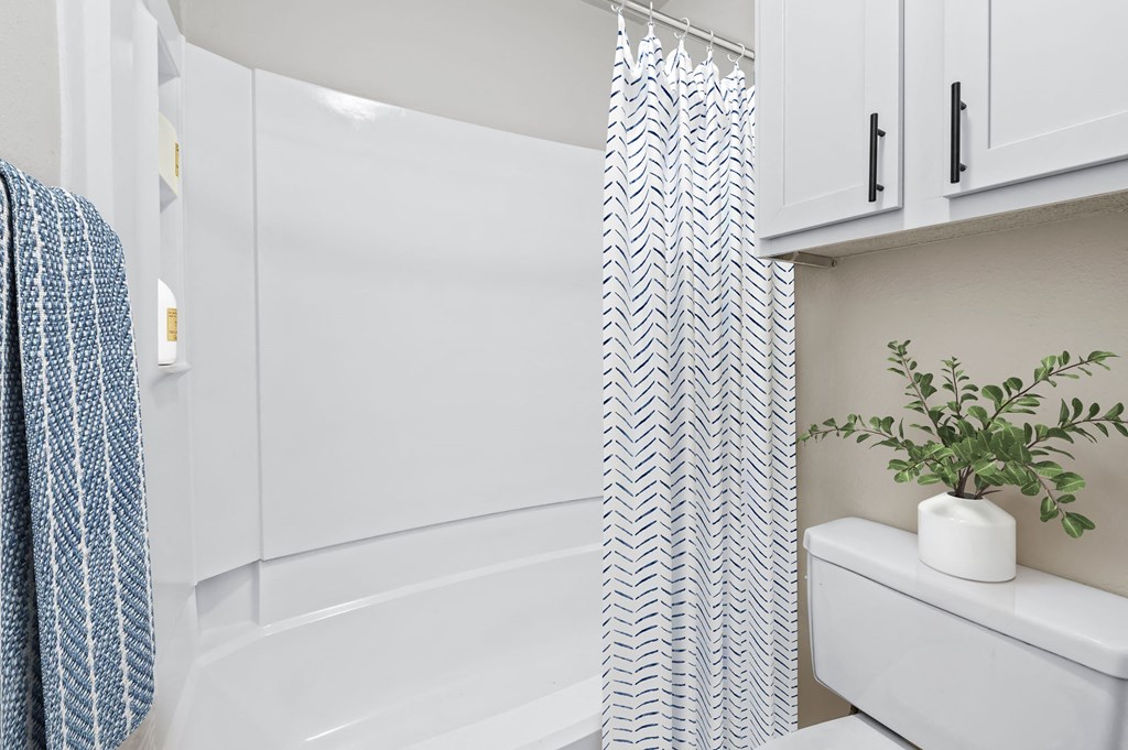 a bathroom with a toilet and a bathtub  at Carmel at Deerfield, San Antonio, Texas