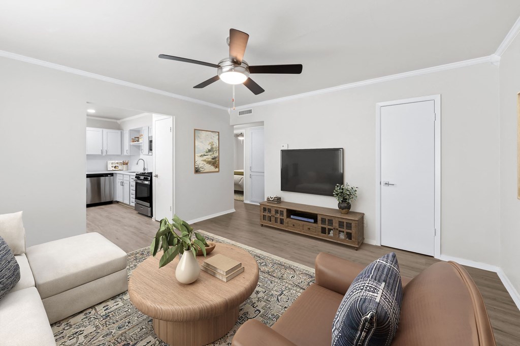 a living room with a ceiling fan and a coffee table in the middle of the room  at Sunset Heights, Texas, 78209