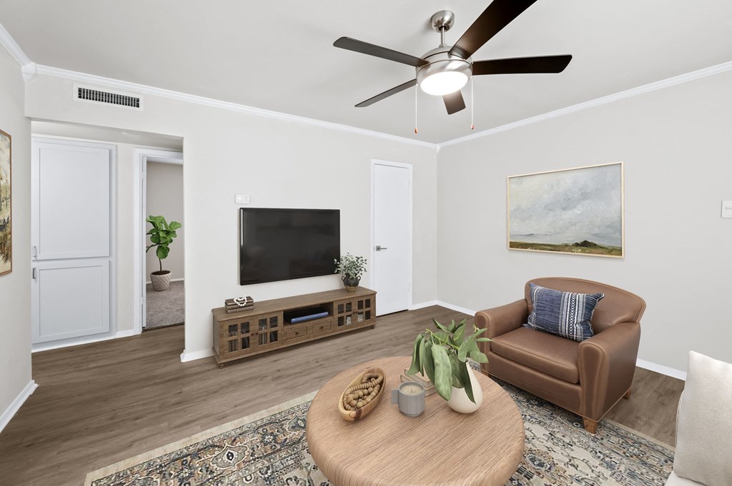 a living room with a ceiling fan and a couch  at Sunset Heights, Texas