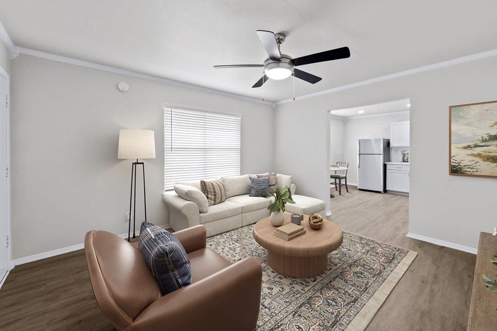 a living room with a couch coffee table and a ceiling fan  at Sunset Heights, Texas