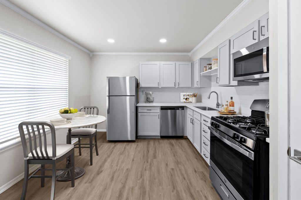 a kitchen with white cabinetry and stainless steel appliances  at Sunset Heights, San Antonio, TX, 78209