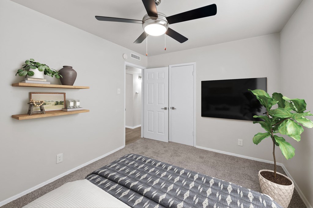 a bedroom with a ceiling fan and a tv on the wall  at Sunset Heights, San Antonio, TX