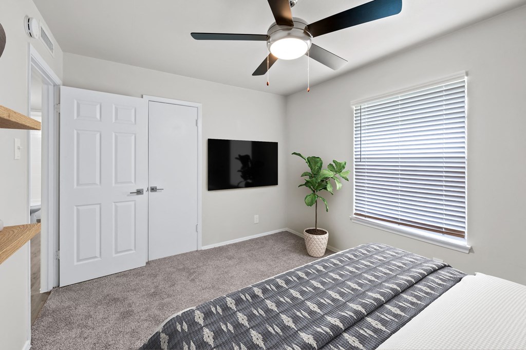 a bedroom with a ceiling fan and a window with a blind  at Sunset Heights, Texas, 78209