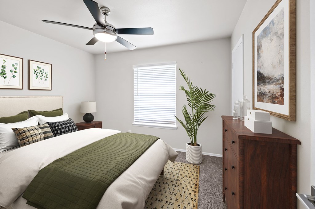 a bedroom with a large bed and a ceiling fan  at Sunset Heights, Texas