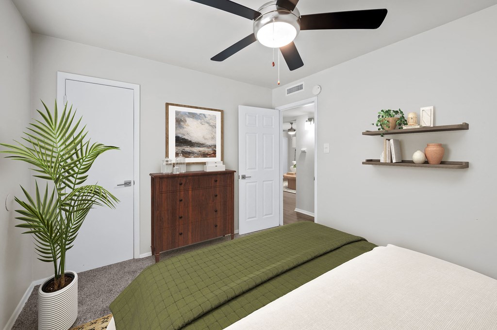 a bedroom with a bed and a ceiling fan  at Sunset Heights, San Antonio