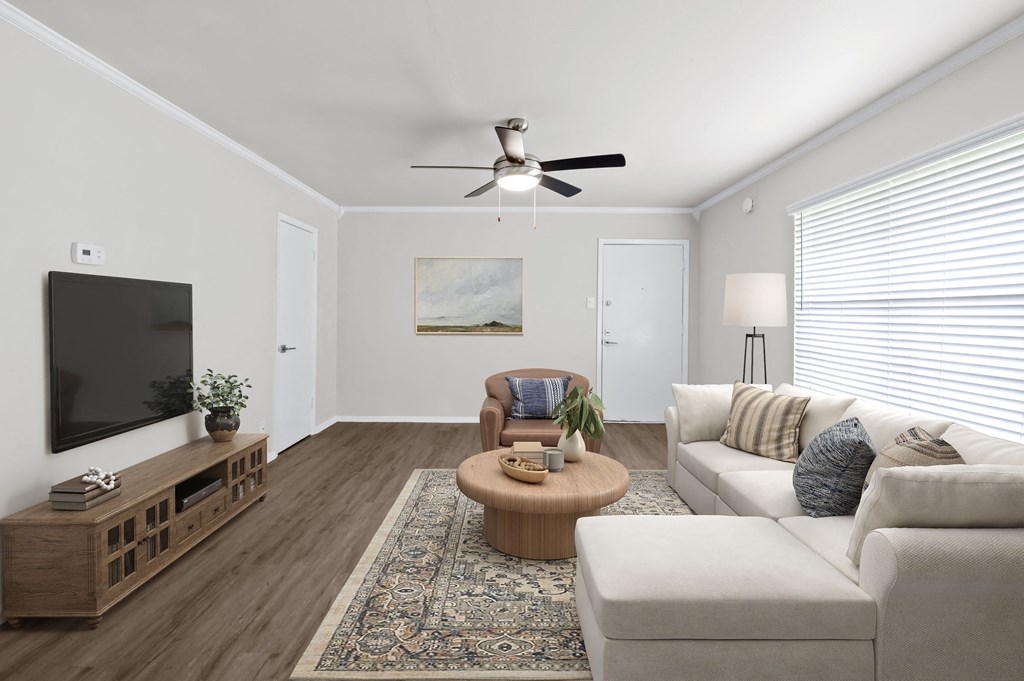 a living room with white walls and a large window  at Sunset Heights, San Antonio