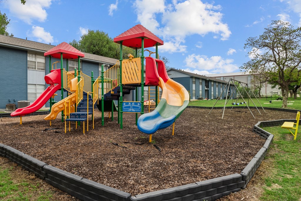 a playground at the whispering winds apartments in pearland, tx  at Sunset Heights, San Antonio, TX