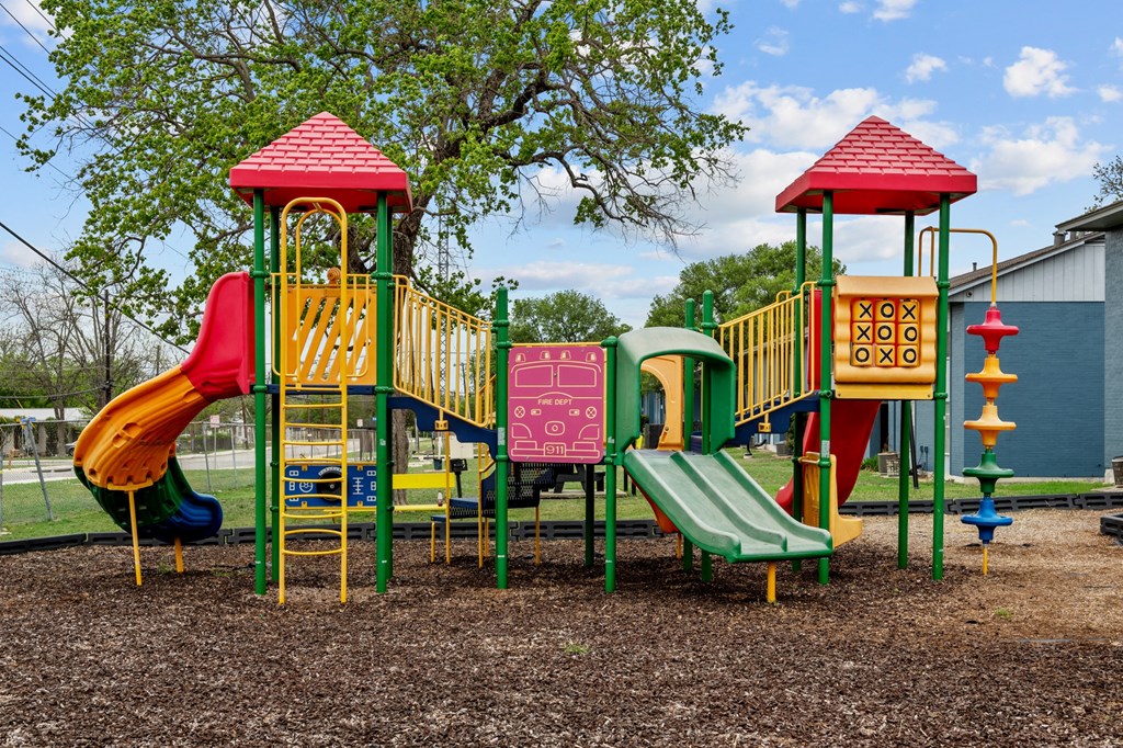 a colorful playground with slides and climbers  at Sunset Heights, Texas