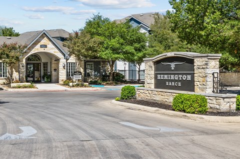 the building where the hotel is located has a sign that says at Remington Ranch, San Antonio, 78247