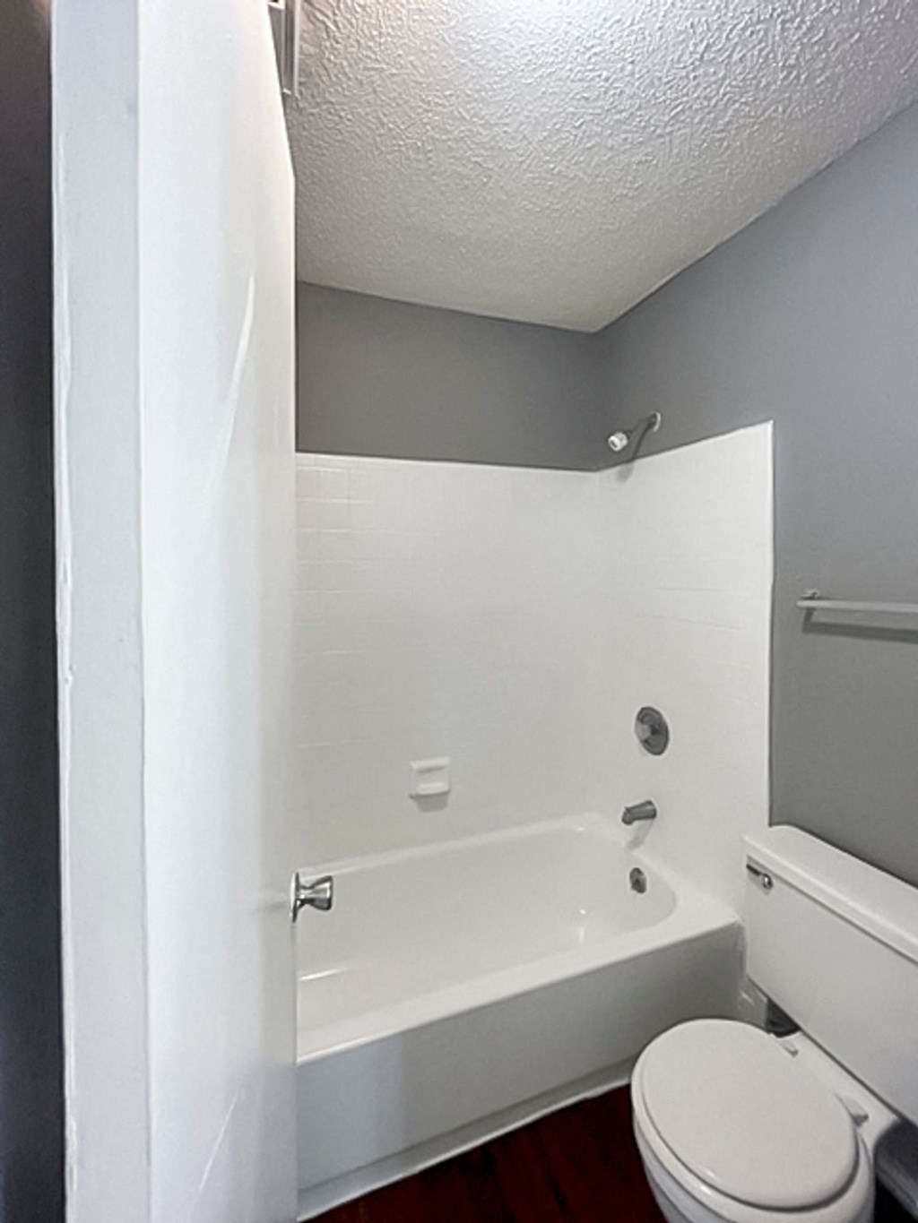 a bathroom with a toilet and a bathtub at The Frederick, San Antonio, TX 78240