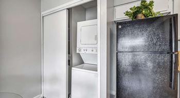 A black fridge is on the right and a white fridge is on the left.