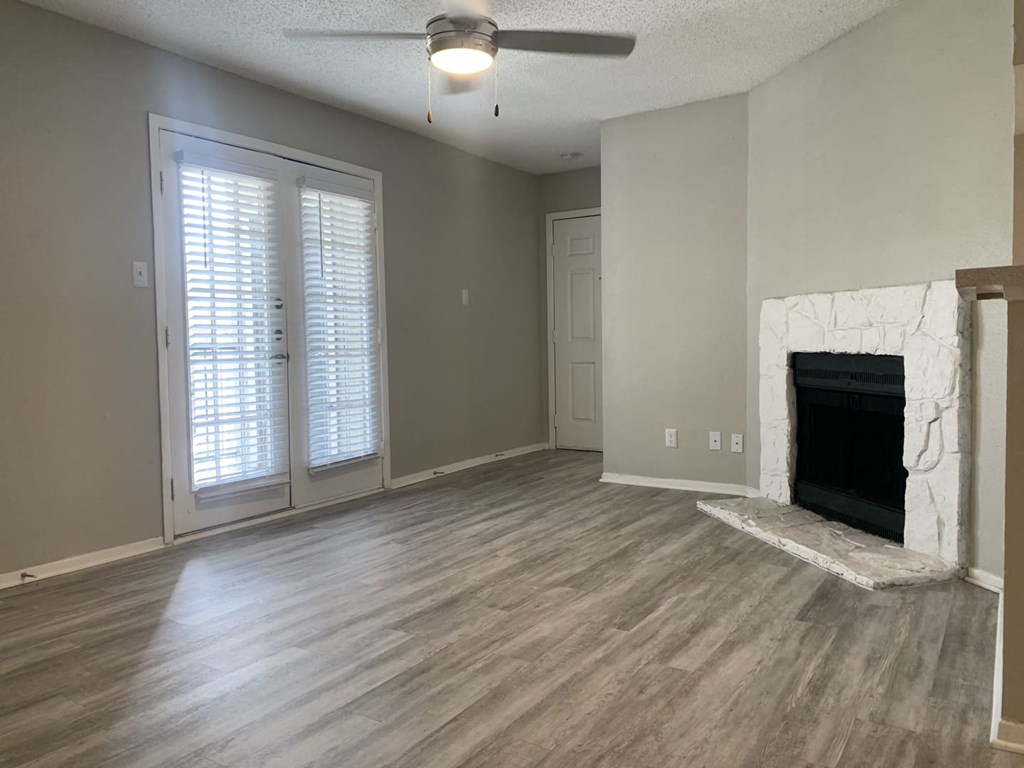 an empty living room with a fireplace