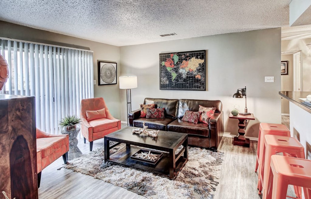 Living Room with lots of natural light and hardwood style floors at The Hills at Ironhorse, North Richland Hills
