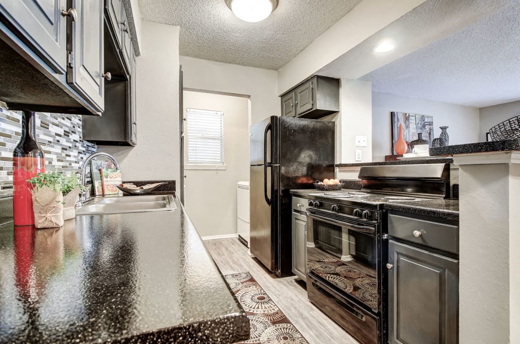 Spacious Kitchen with Black Appliances at The Hills at Ironhorse, Texas