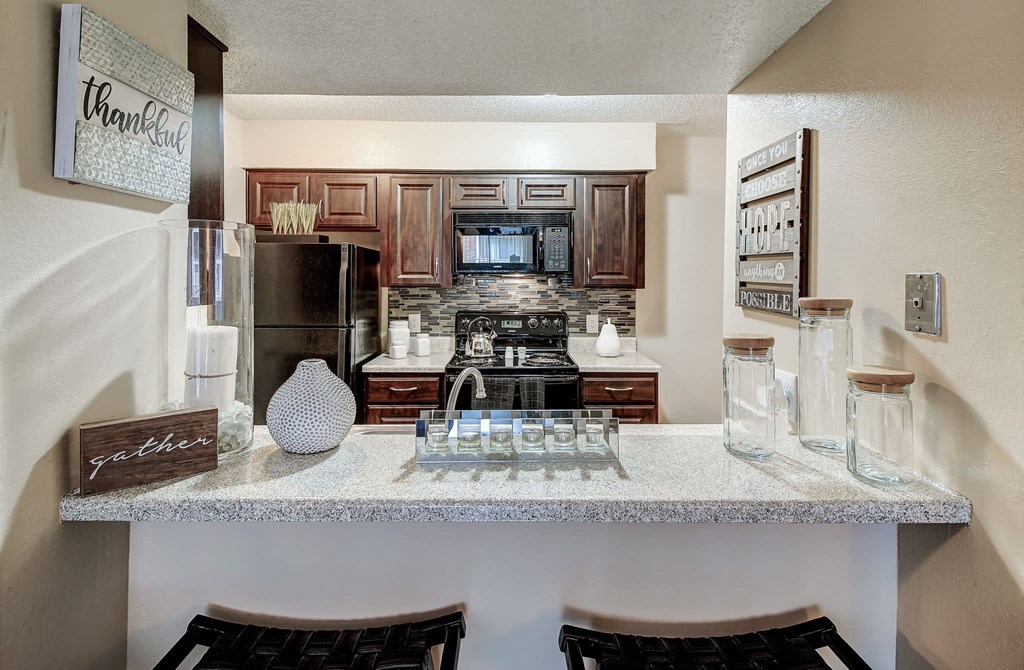 Stunning eat in kitchen with espresso cabinets and modern backsplash at The Hudson, Texas, 76180