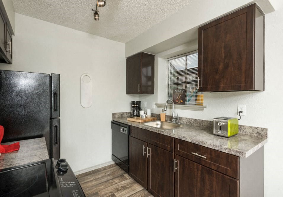 Classic Kitchen with Custom Walnut Cabinets at Maxwell Townhomes, San Antonio