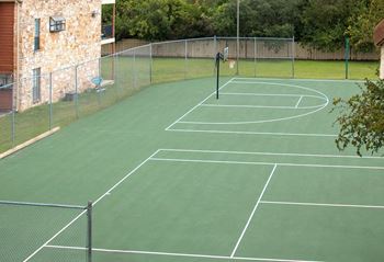a tennis court with a net on top of it at The Broadwater at Salado Creek, San Antonio, Texas, 78216