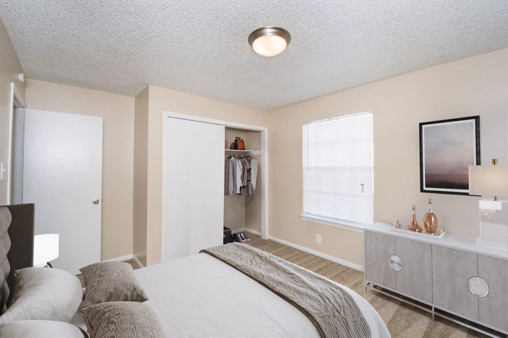 a bedroom with a bed and a dresser and a window at Tradewinds, Windcrest