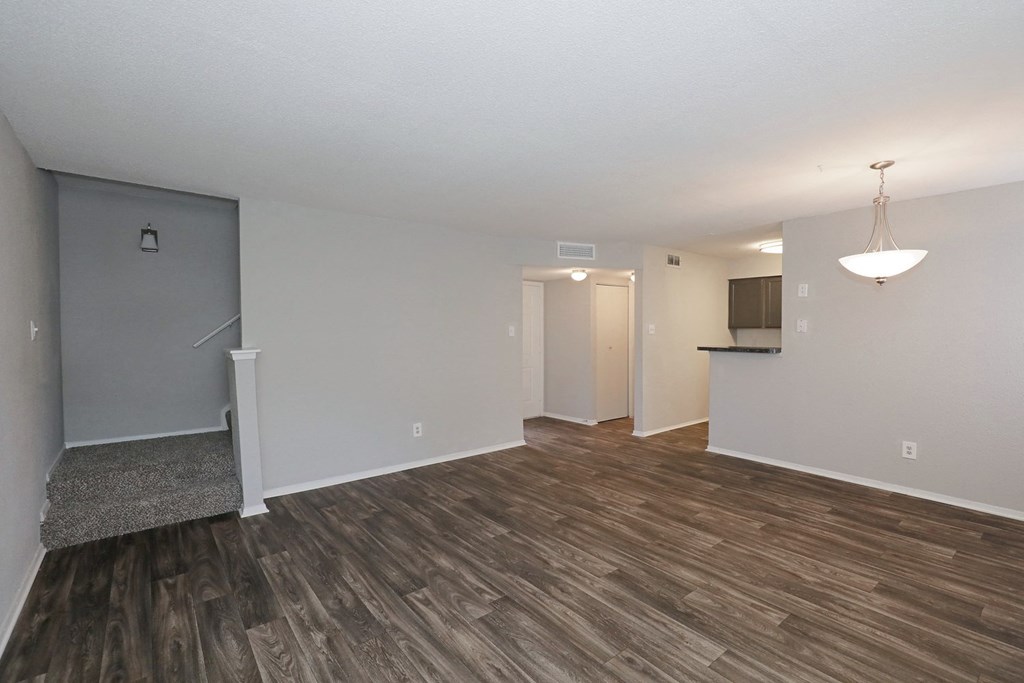 a living room with hardwood floors and grey walls