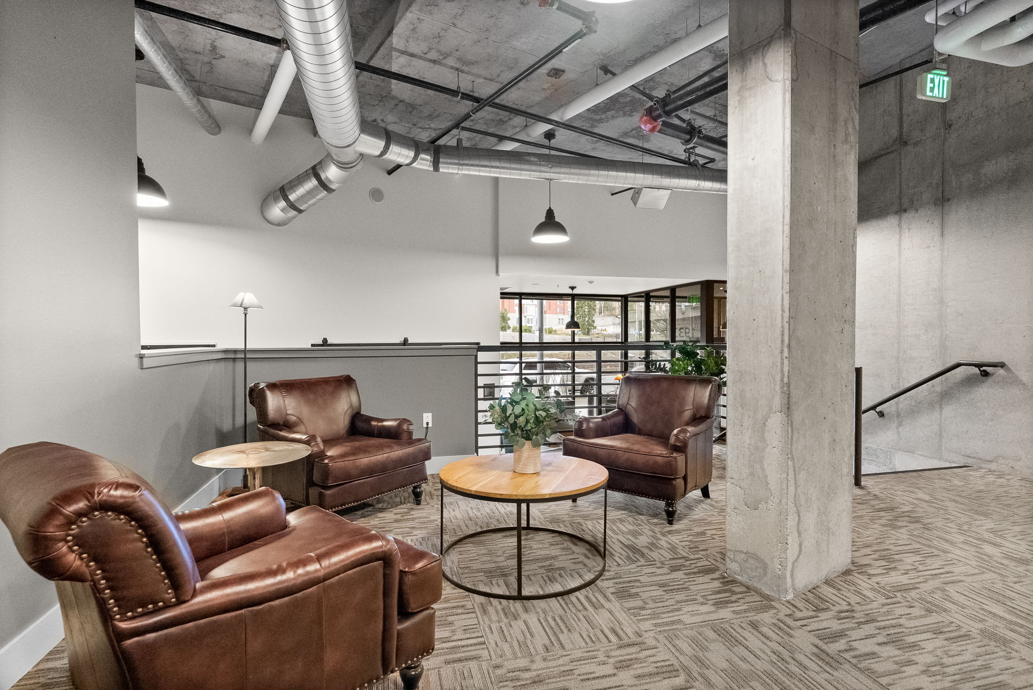 a living room with leather chairs and a table