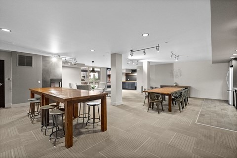 a large dining room with tables and chairs and a kitchen