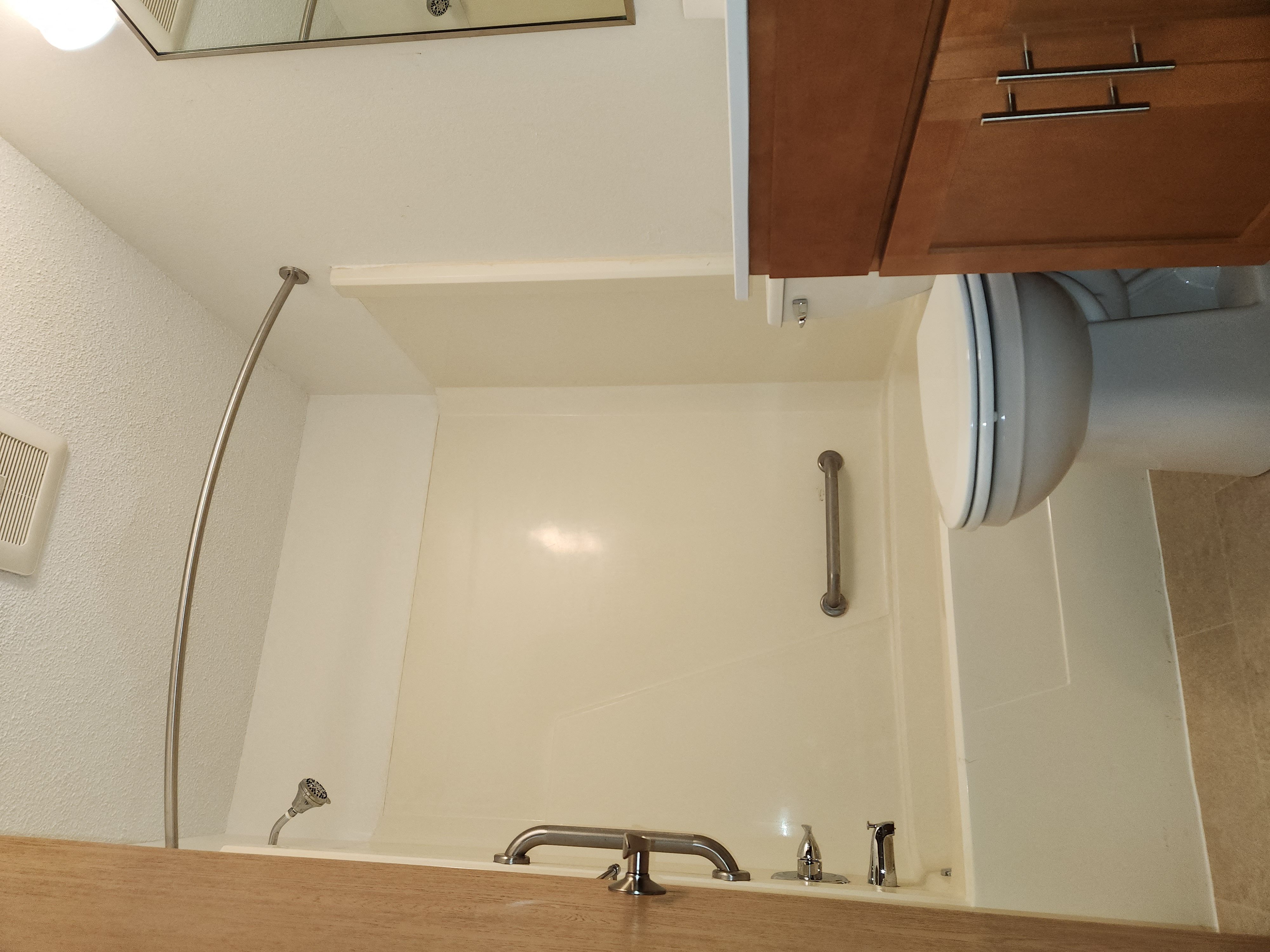 a kitchen with a sink and a faucet in the corner of a room