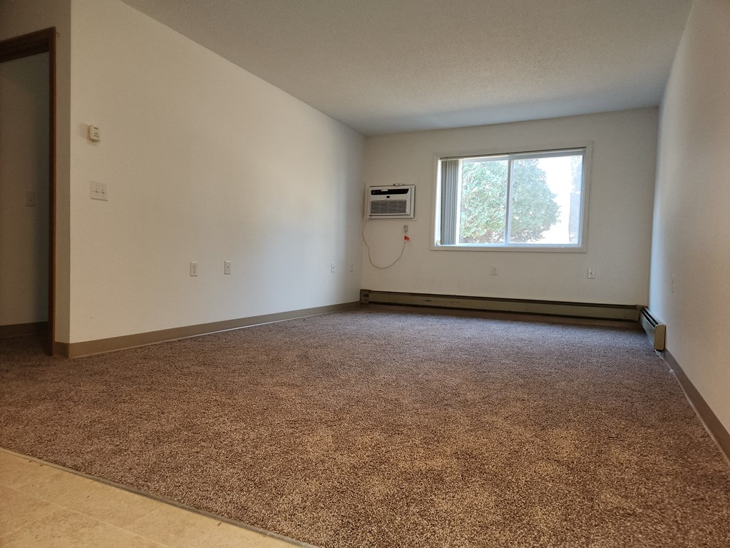 the living room of an empty house with a window